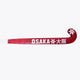Hot pink field hockey stick blade with printed OSAKA branding and star icon