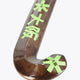 Field hockey stick head and curve, dark wood finish with neon green graphic marks