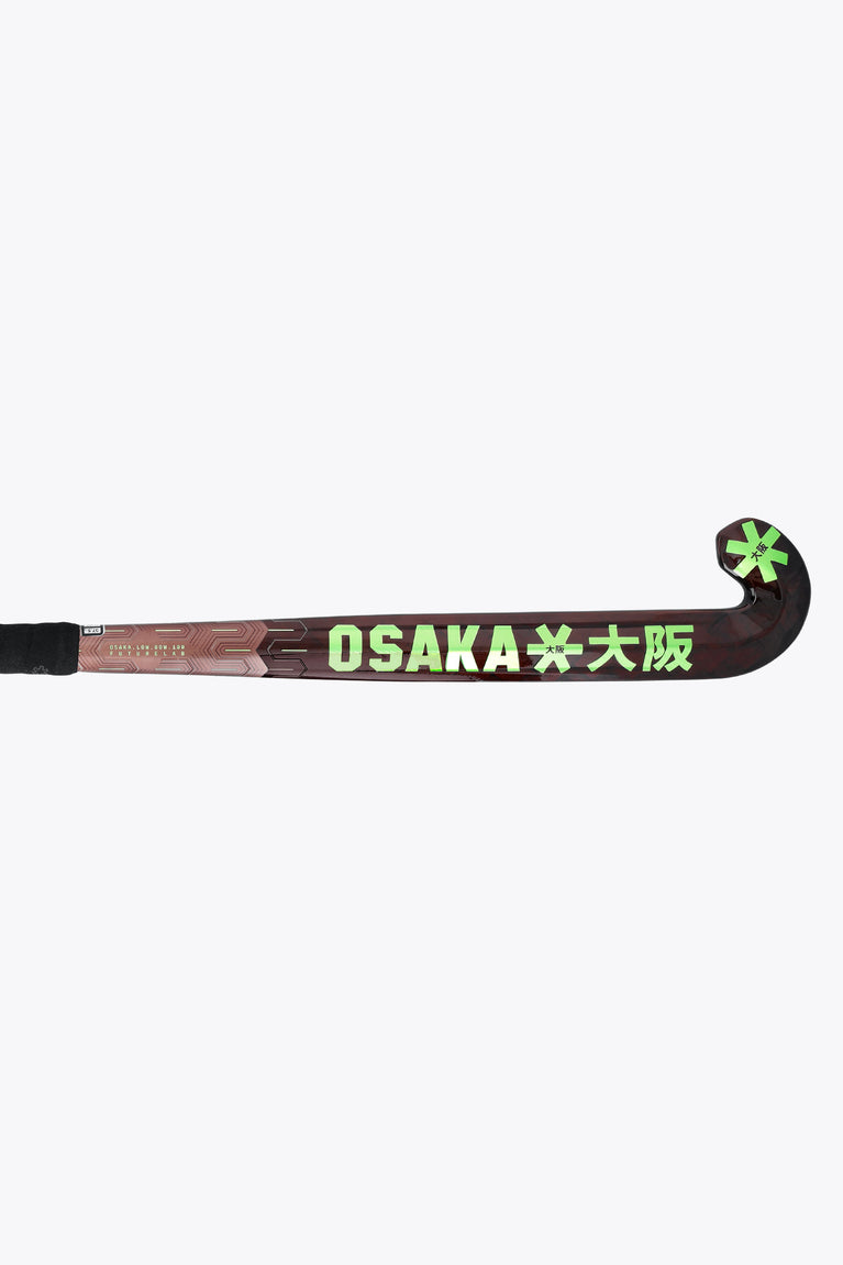 Field hockey stick blade with OSAKA branding and green star accents, black grip end