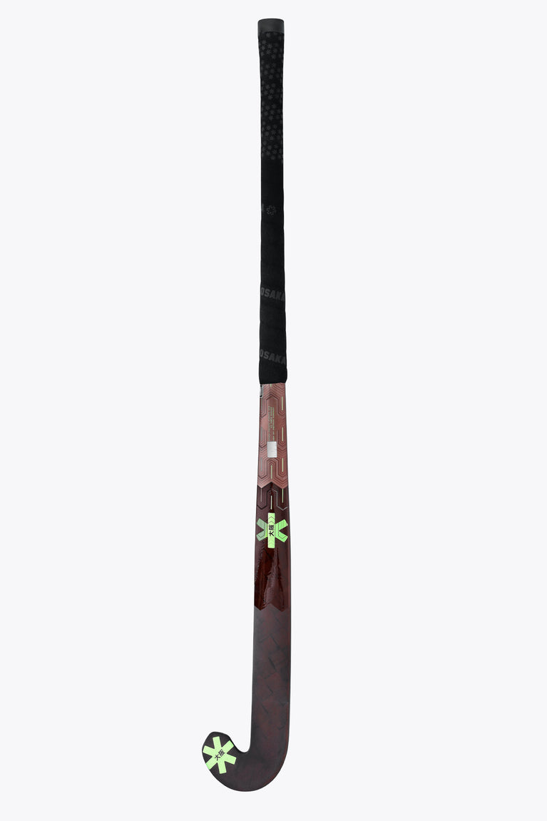 Field hockey stick with black grip and green star accents on dark brown shaft