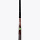 Field hockey stick with black grip and green star accents on dark brown shaft