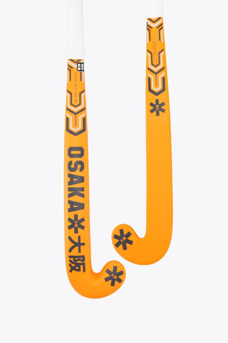 Orange field hockey stick with Osaka graphics and mid-bow curved head