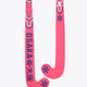Hot pink mid-bow field hockey stick with patterned grip at the handle