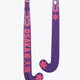 Royal purple field hockey stick with red geometric graphics, mid-bow curved head.