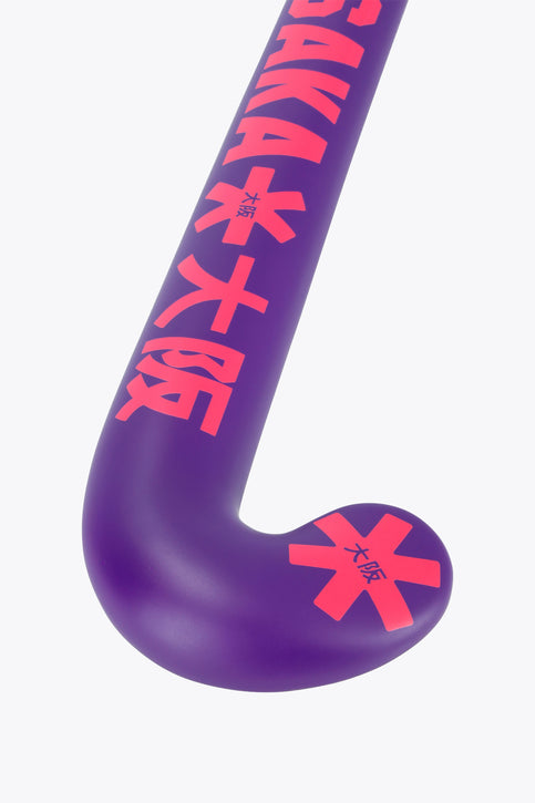 Osaka Field Hockey Stick Mid Bow GF | Royal Purple Royal purple field hockey stick with red geometric graphics, mid-bow curved head.