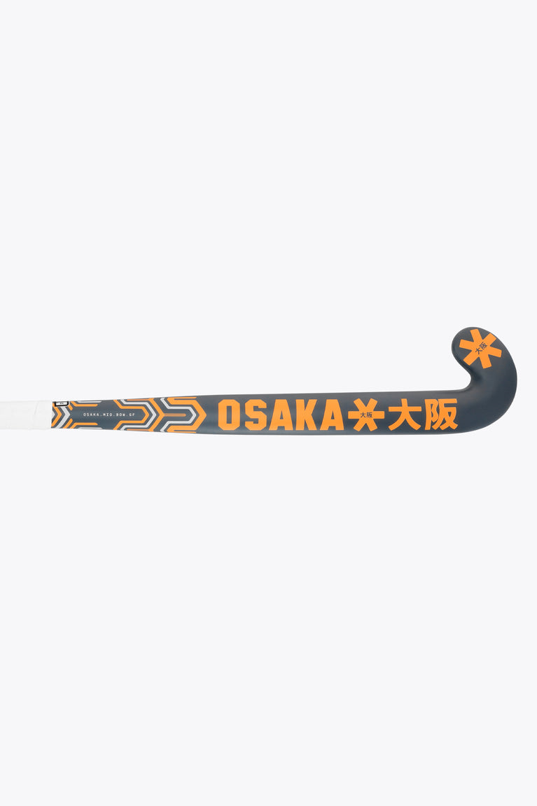 Field hockey stick mid-shaft, dark gray with orange 'OSAKA' lettering and logos