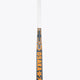 Field hockey stick shaft with white grip, orange and gray patterned section