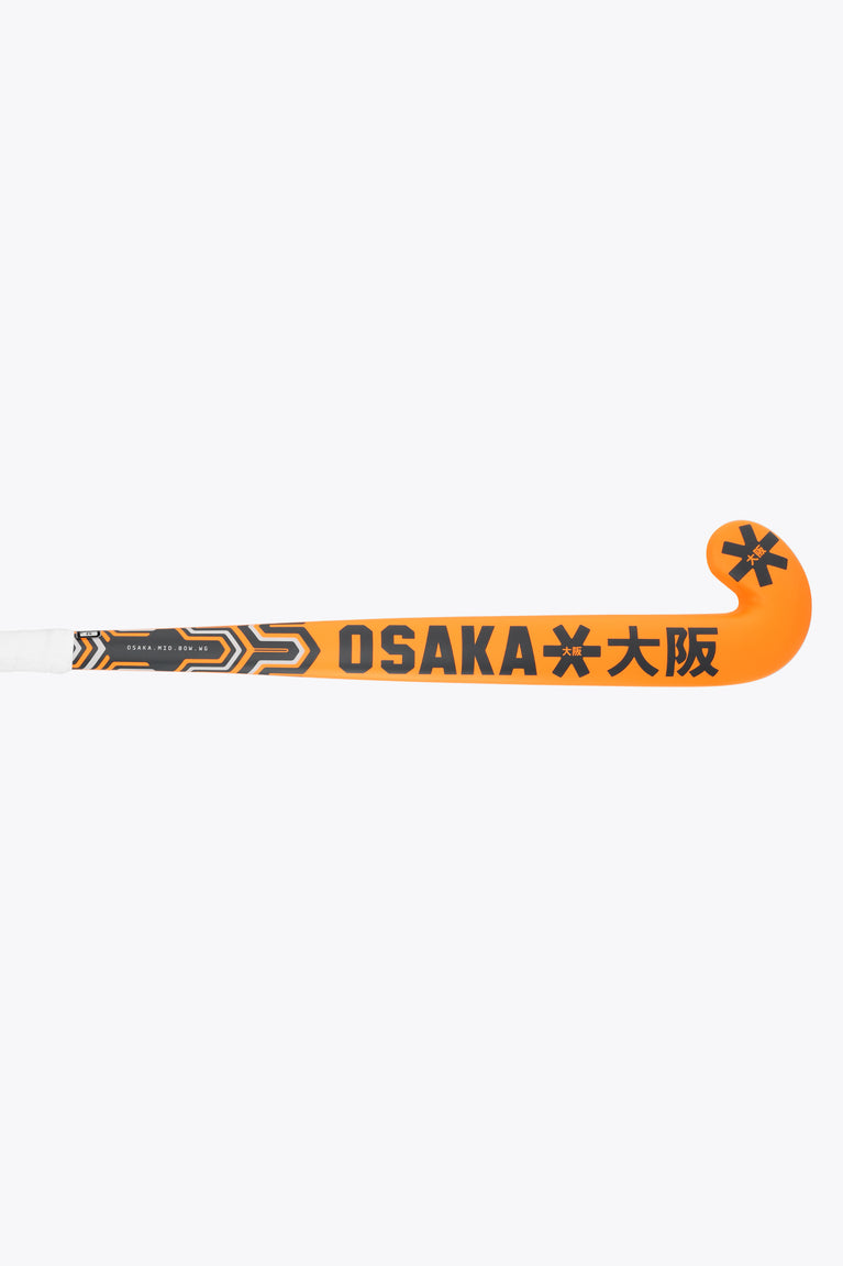 Orange field hockey stick with Osaka branding and geometric graphics