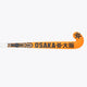 Orange field hockey stick with Osaka branding and geometric graphics