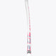 White field hockey stick shaft with hot pink and blue end graphics, close side view