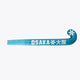 Blue field hockey stick blade with OSKAKA lettering and end-cap snowflake logo