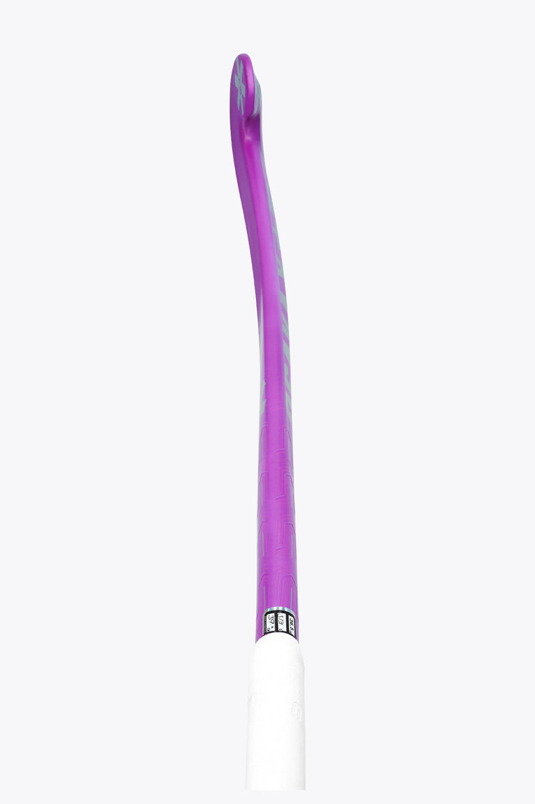 Purple field hockey stick with white grip section at the handle end