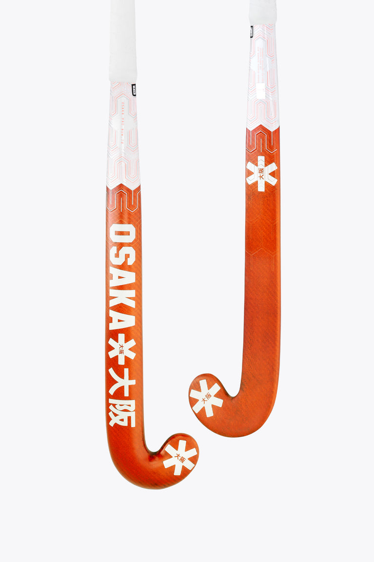 Bright orange field hockey stick with white shaft and curved U-shaped head