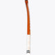 Field hockey stick with orange top edge and white shaft, vertical side view