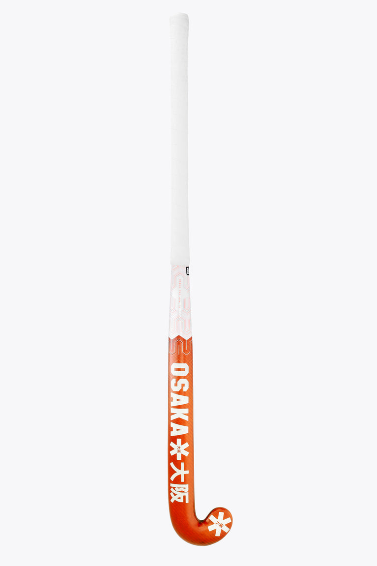 Field hockey stick with orange grip area and white shaft, branding near handle
