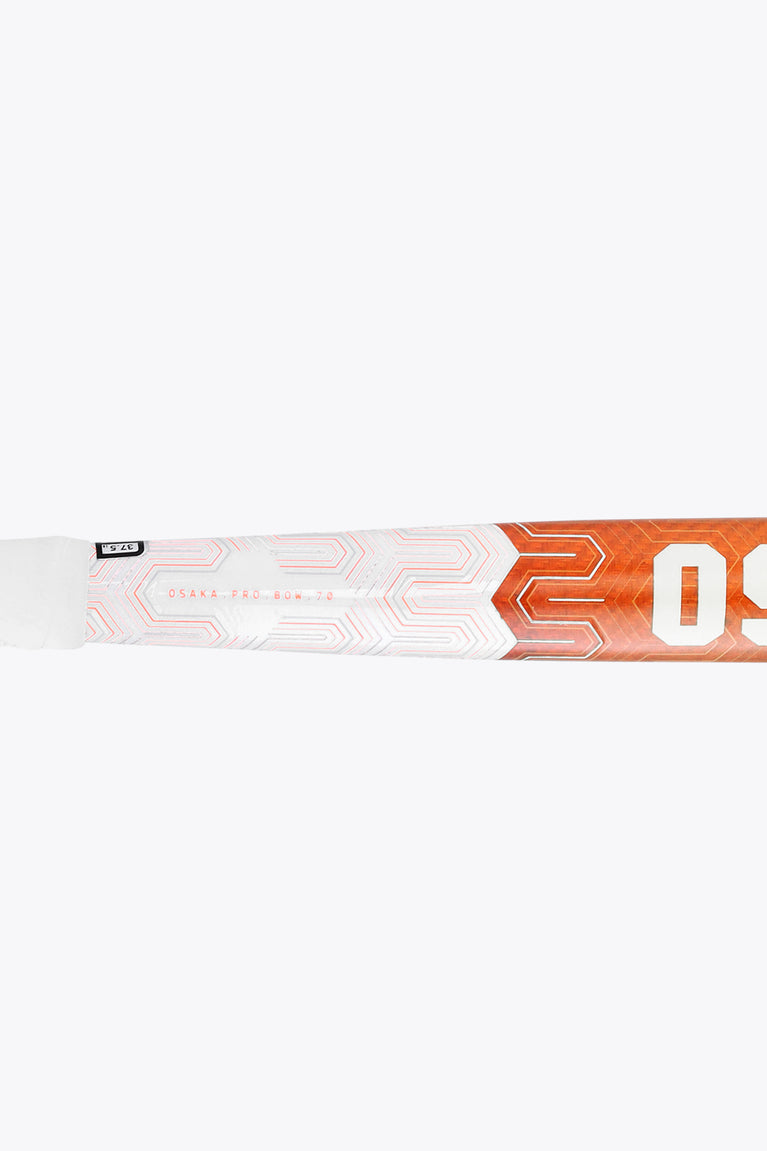 Field hockey stick shaft close-up with orange branding and geometric pattern
