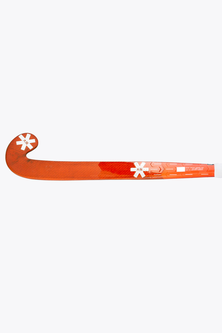 Bright orange field hockey stick with long blade and star markers