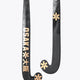 Field hockey stick with dark shaft and gold Osaka graphics on curved blade