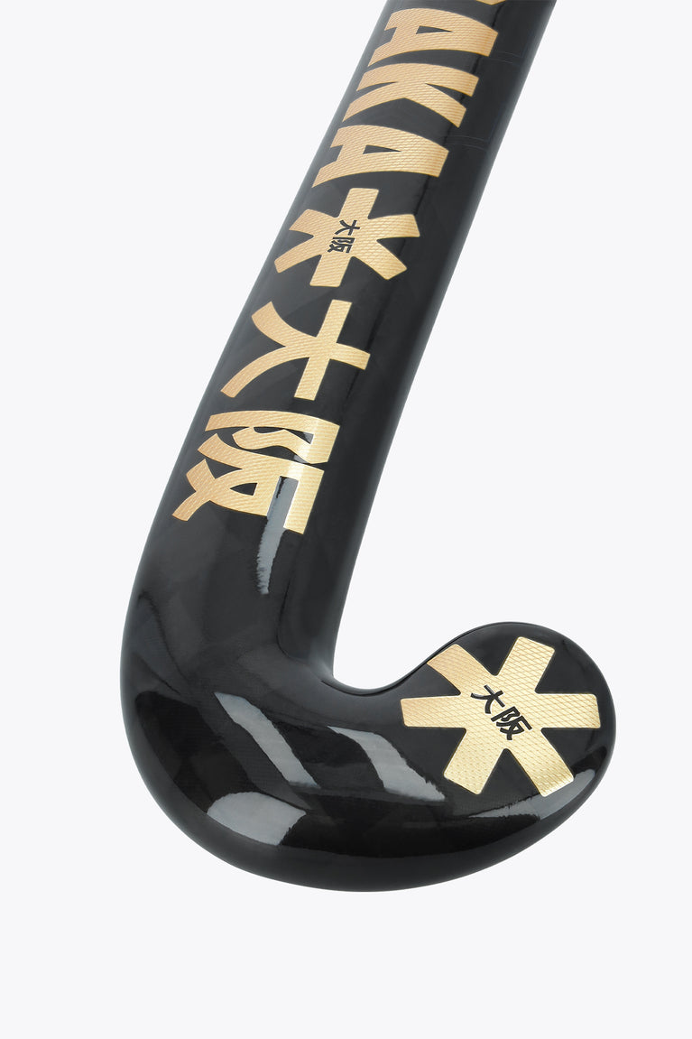 Field hockey stick blade end with dark face and gold star-style markings