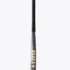 Field hockey stick top grip with textured dark surface and gold branding on shaft