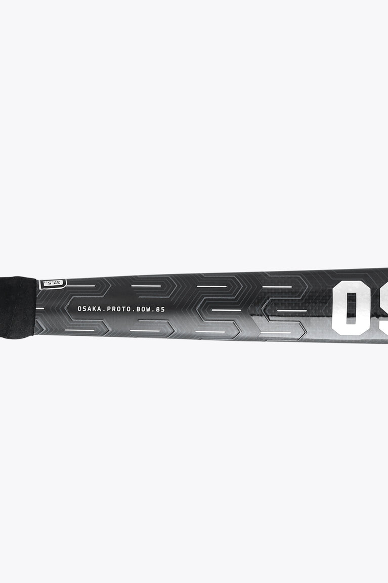 Dark field hockey stick shaft with geometric graphics and a visible “85” marking
