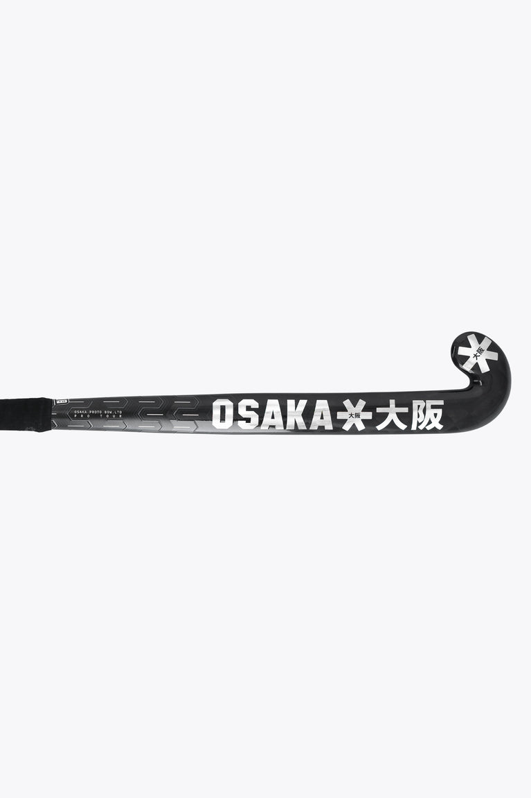 Field hockey stick shaft side, black stick with OSAKA lettering and star head logo