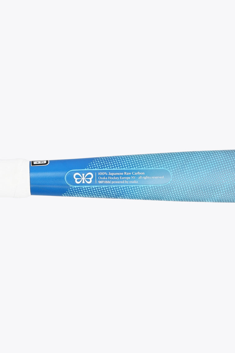 Field hockey stick shaft close-up with blue pastel finish and printed label near handle