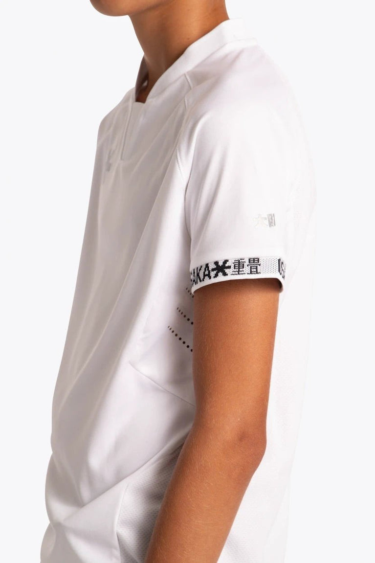 Boy wearing the Osaka Kids Jersey in white. Side view