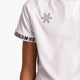 Boy wearing the Osaka Kids Jersey in white. Front detail logo view