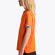 Girl wearing the Osaka Kids Jersey in Orange. Side view