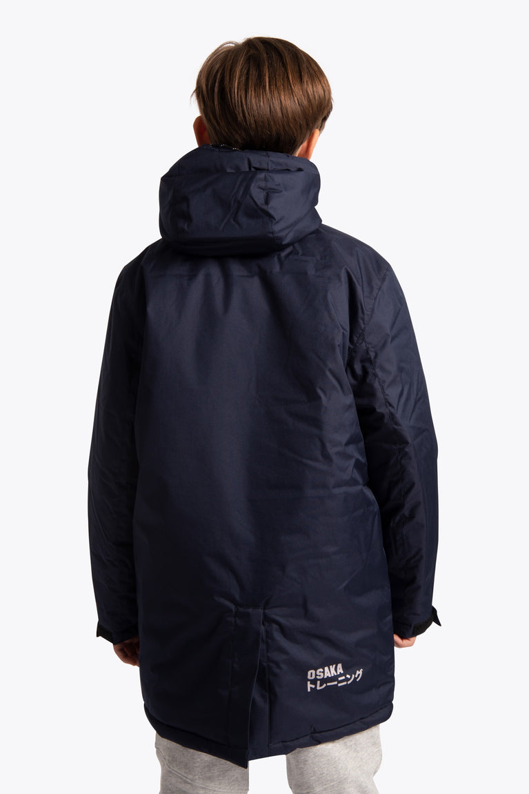 Boy wearing the Osaka Kids Stadium Jacket in Navy. Back view