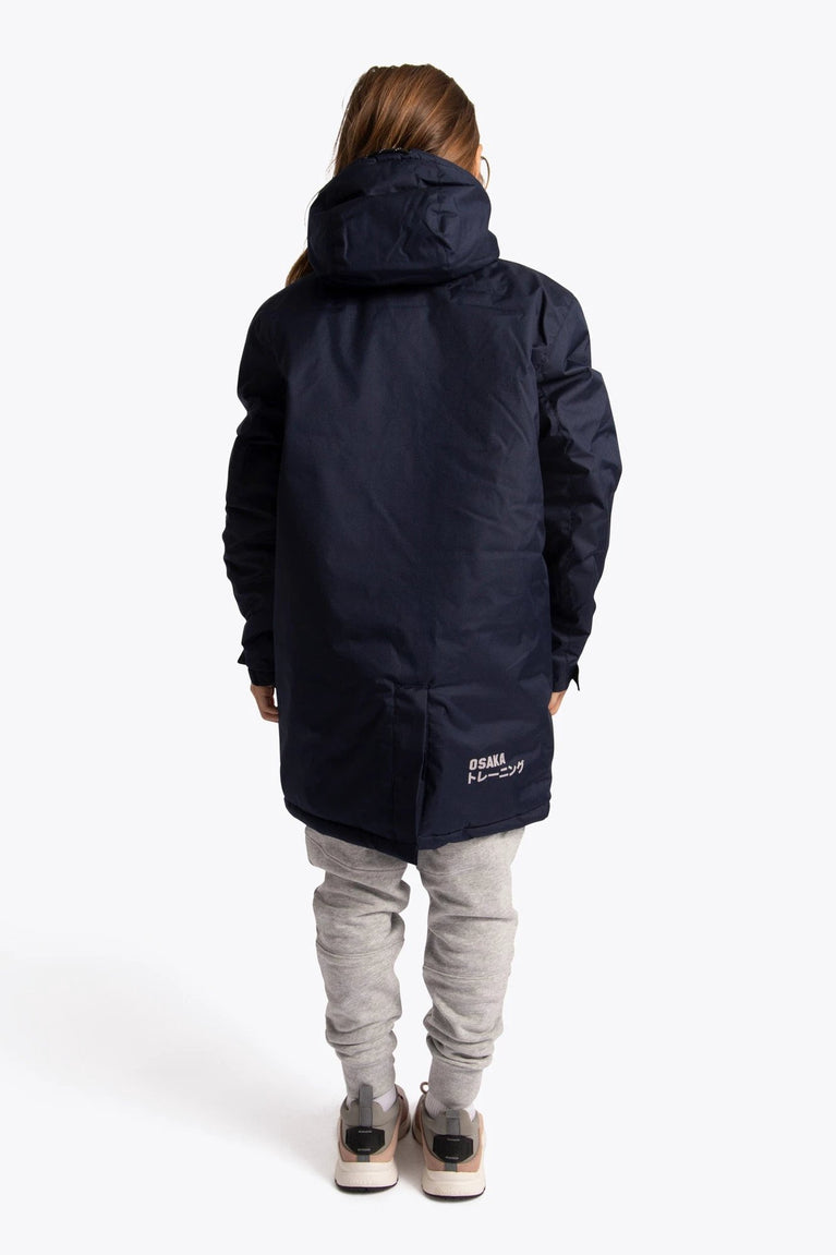 Boy wearing the Osaka Kids Stadium Jacket in Navy. Back view