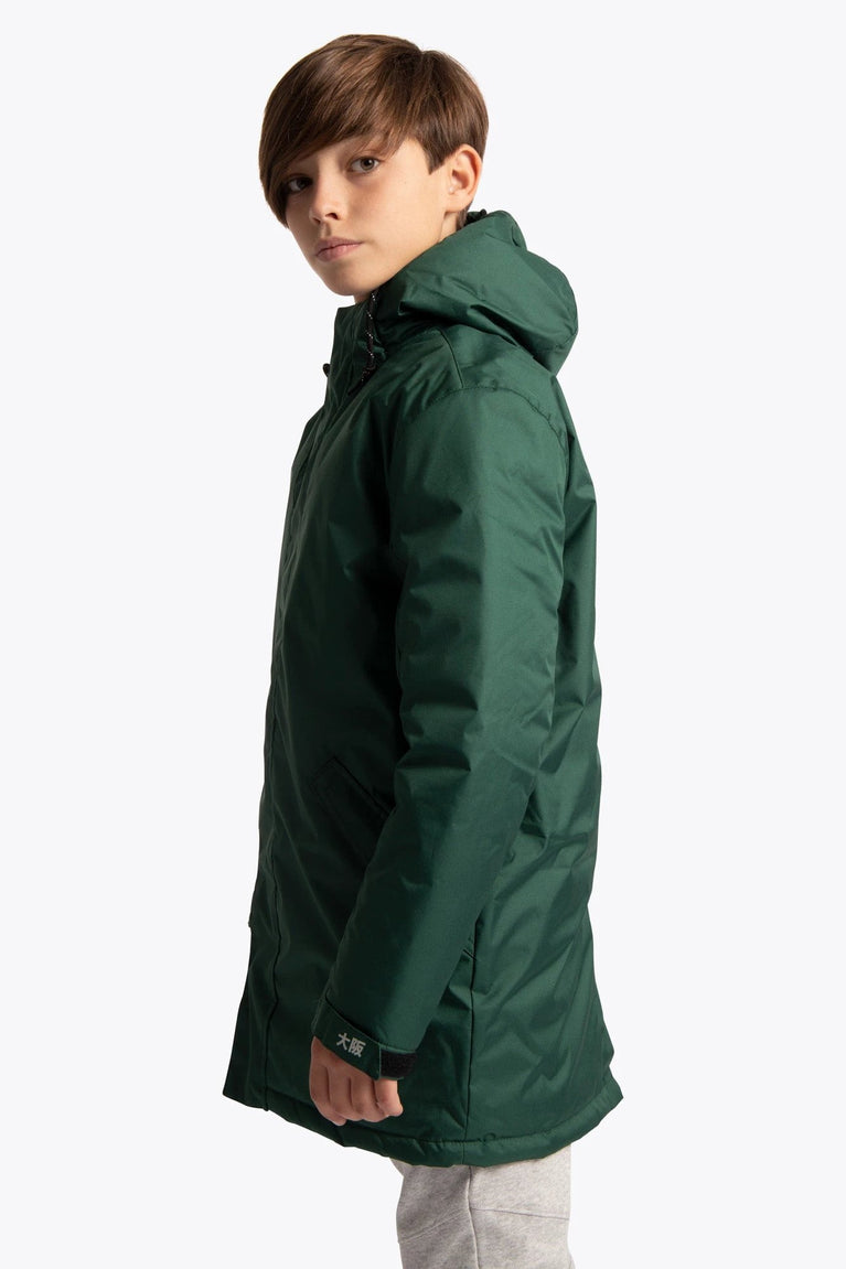 Boy wearing the Osaka Kids Stadium Jacket in Dark Green. Side view
