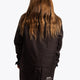 Girl wearing the Osaka Kids Stadium Jacket in Black. Back view