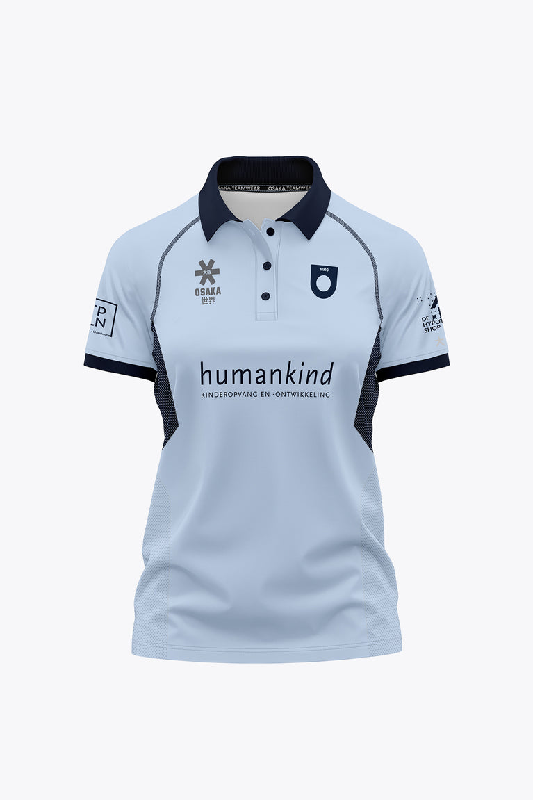 Women’s sky blue polo jersey with navy collar, button placket, and front graphic print