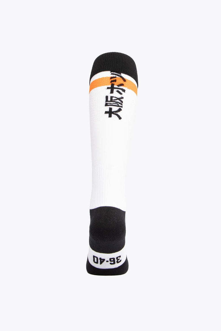 MHCO Field Hockey Socks in white and orange with Osaka logo in green. Back view