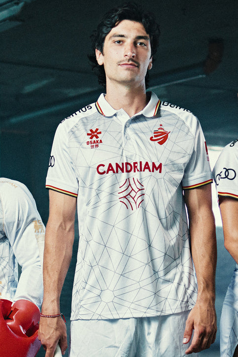 White soccer shorts with elastic waistband and team logos at hem