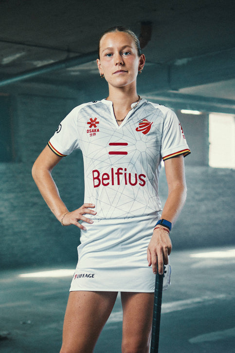 White women’s Belgium polo jersey with V-neck, short sleeves, red logos and trim