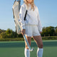 Small sports stickbag carried on shoulder; white with black straps and trim