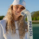White Yibbi twill cap worn with blue embroidered logo