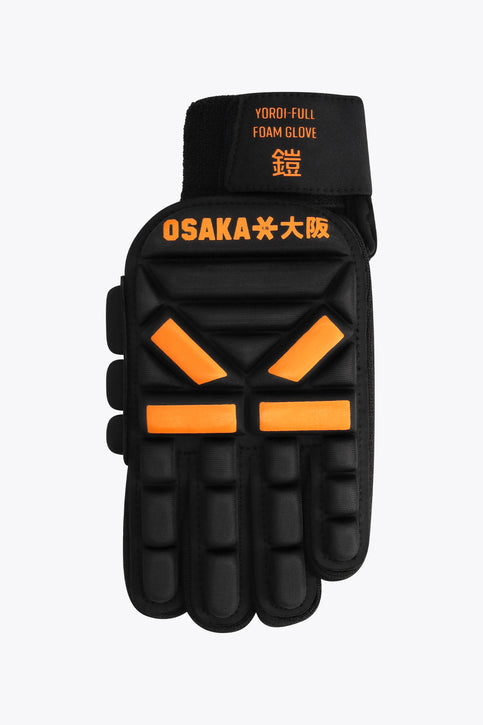 Left-hand hockey indoor glove, black with orange foam knuckle pads and grip fingers.