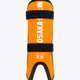 Kids shin guard in orange with black straps and logo text