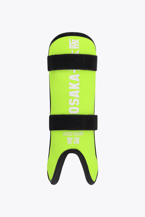 Kids lime green shin guard with black straps and visible OSAKA logo
