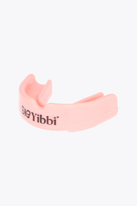 Pastel pink mouth guard with Yibbi branding