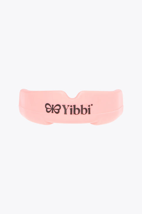 Pastel pink mouth guard with Yibbi branding