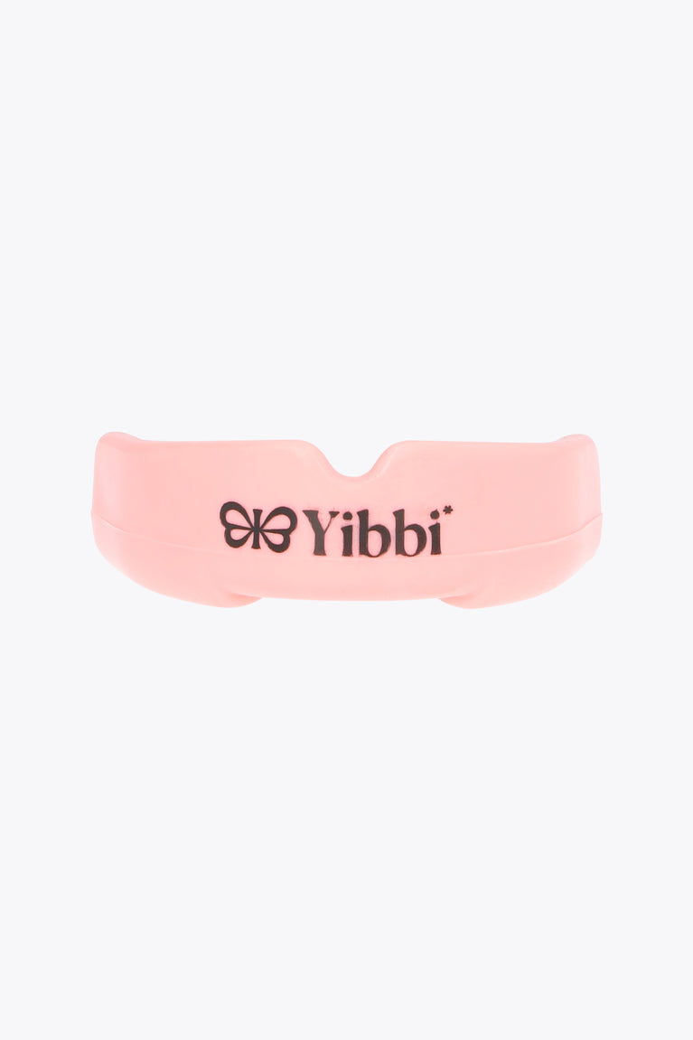 Pastel pink mouth guard with Yibbi logo on the front