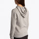 Girl wearing the Osaka kids hoodie in grey with blue star logo. Side/back view