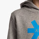 Boy wearing the Osaka kids hoodie in grey with blue star logo. Detail view shoulder