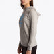 Girl wearing the Osaka kids hoodie in grey with blue star logo. Side view