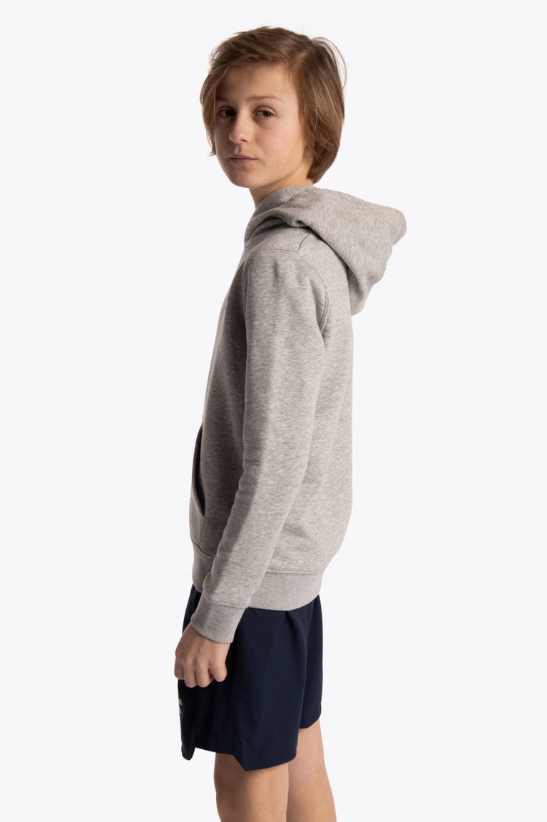 Boy wearing the Osaka kids hoodie in grey with blue star logo. Side view